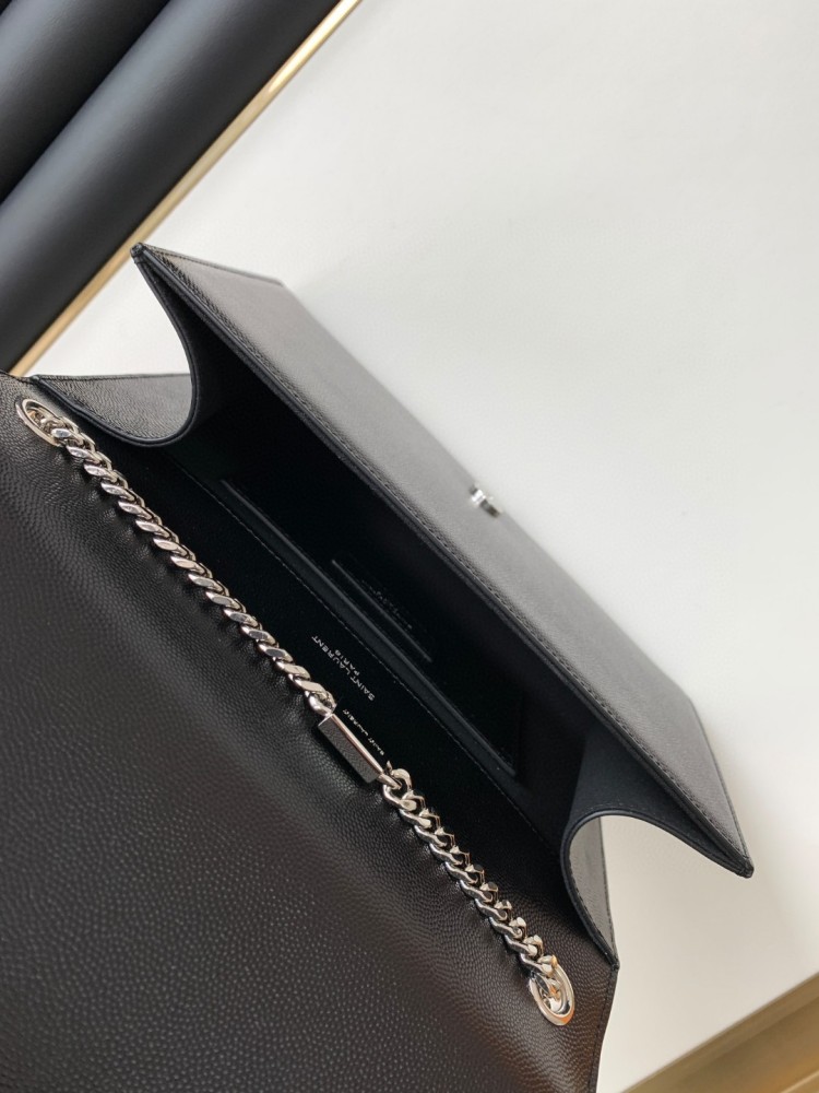 This bag is the classic YSL (Yves Saint Laurent) Kate shoulder bag. It features black caviar leather (pebbled leather) with the iconic silver-tone YSL logo and a silver-tone metal chain.
