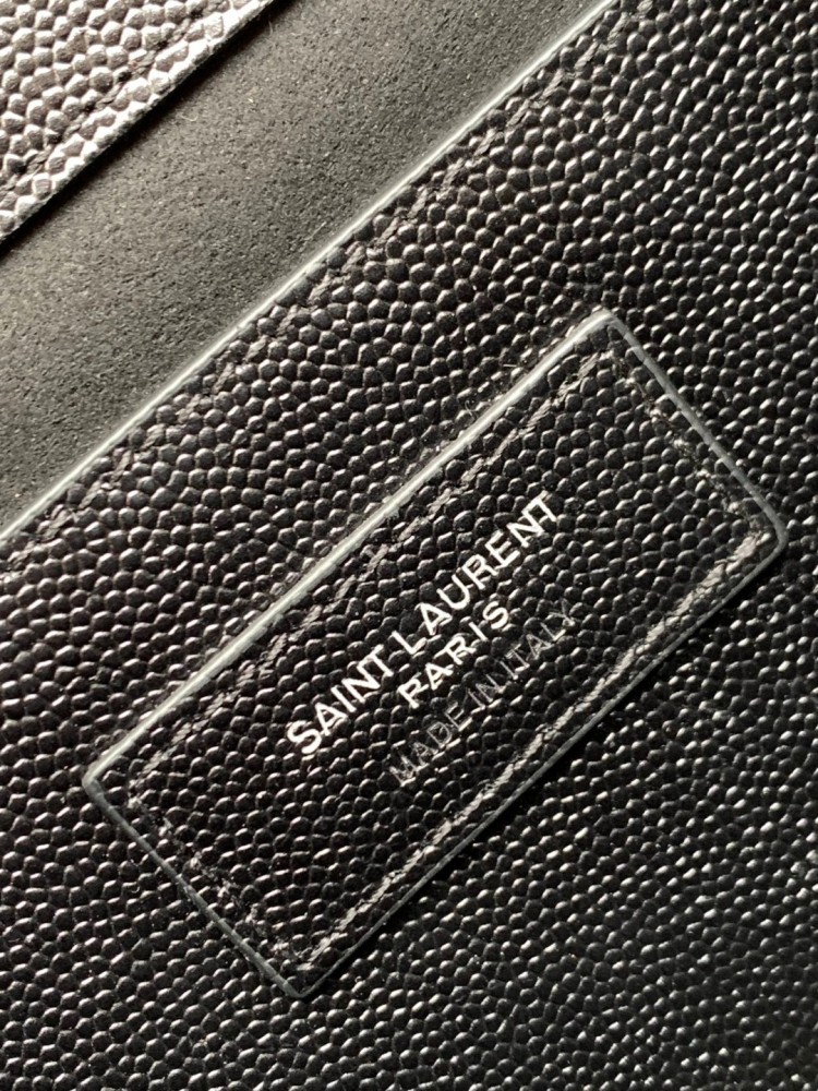 This bag is the classic YSL (Yves Saint Laurent) Kate shoulder bag. It features black caviar leather (pebbled leather) with the iconic silver-tone YSL logo and a silver-tone metal chain.