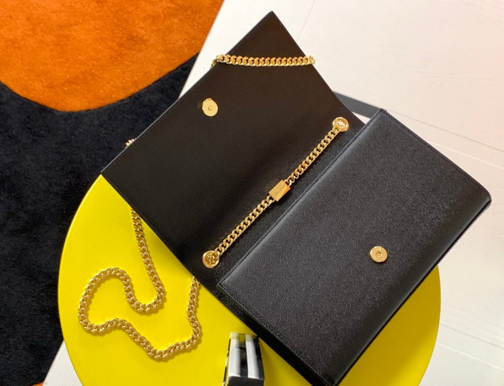 This is the YSL Kate chain bag, crafted in black caviar leather with a gold-tone metal logo and chain strap, no tassel, suitable for shoulder or crossbody wear.