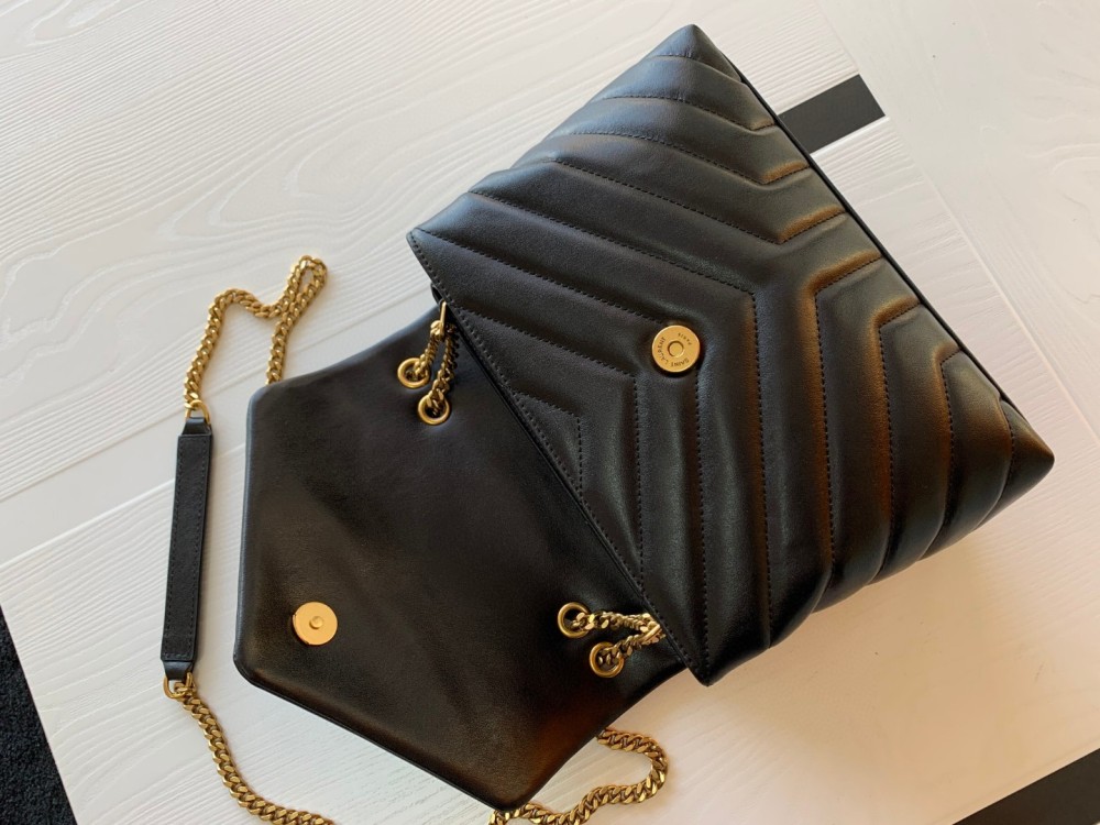 This is the YSL Loulou quilted bag, crafted from black lambskin leather with a gold-tone metal YSL logo and chain. It can be worn as a shoulder, crossbody, or top-handle bag, boasting a sophisticated and versatile style.