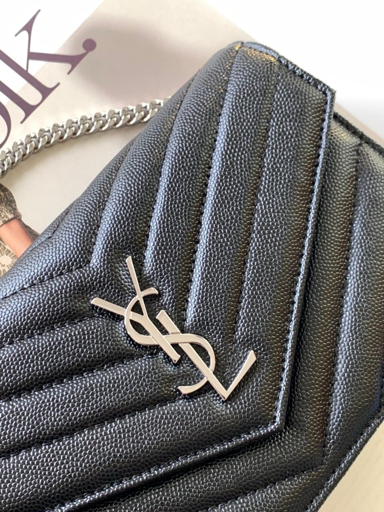This is the YSL Cassandre chain wallet, crafted from black grained leather with quilted detailing and a silver-tone metal YSL logo on the front. It can be worn as a shoulder or crossbody bag, combining practicality with brand recognition.