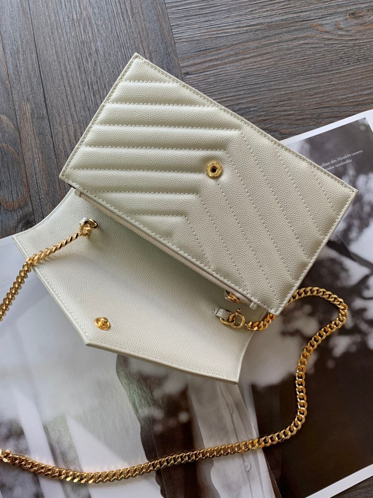 This is the YSL Cassandre chain wallet, crafted from white grained leather with quilted detailing and a gold-tone metal YSL logo on the front. It can be worn as a shoulder or crossbody bag, combining practicality with brand recognition.
