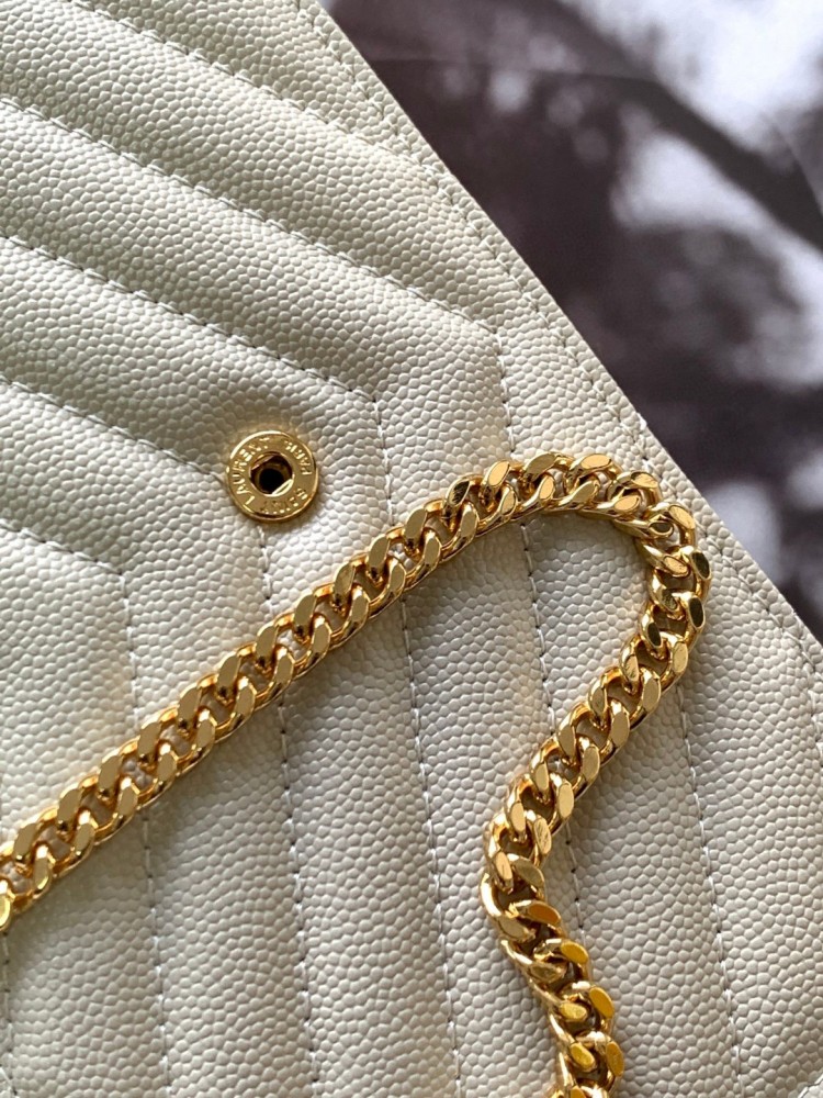 This is the YSL Cassandre chain wallet, crafted from white grained leather with quilted detailing and a gold-tone metal YSL logo on the front. It can be worn as a shoulder or crossbody bag, combining practicality with brand recognition.