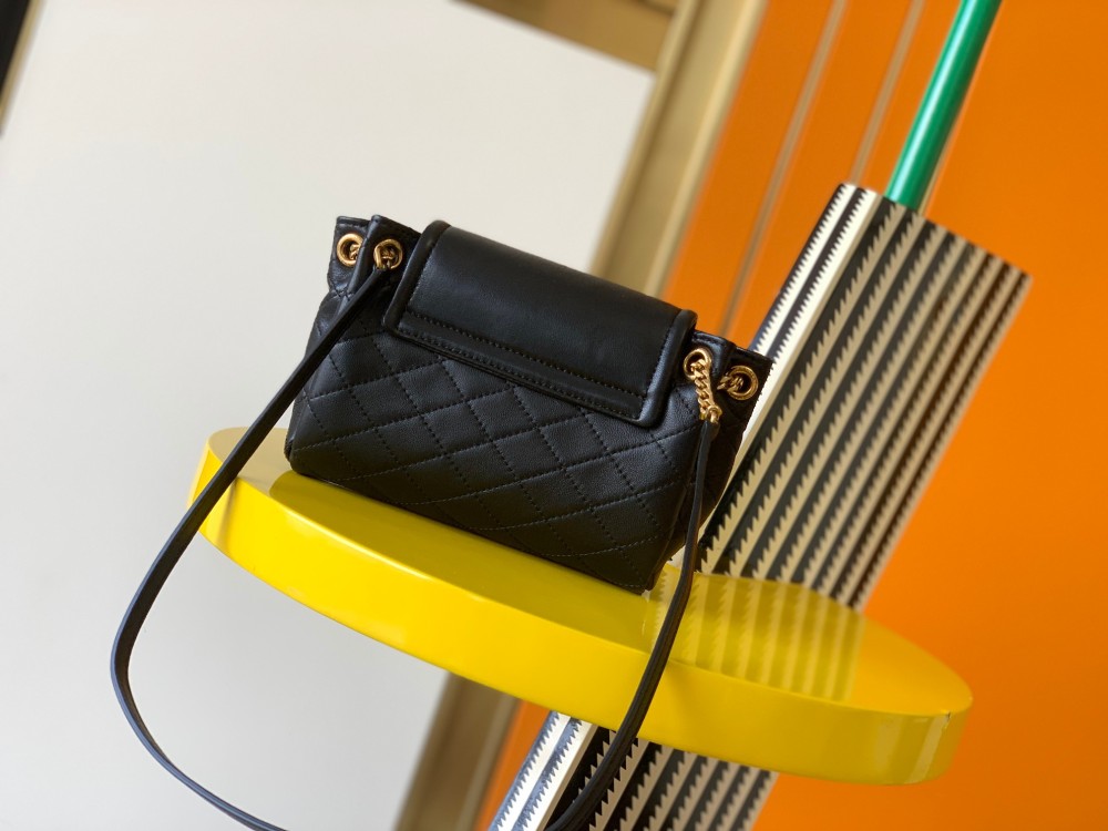 This is a quilted chain bag from YSL (Yves Saint Laurent), crafted from soft black leather with a gold-tone metal YSL logo and chain strap. It features a sleek and sophisticated design, suitable for shoulder or crossbody wear.