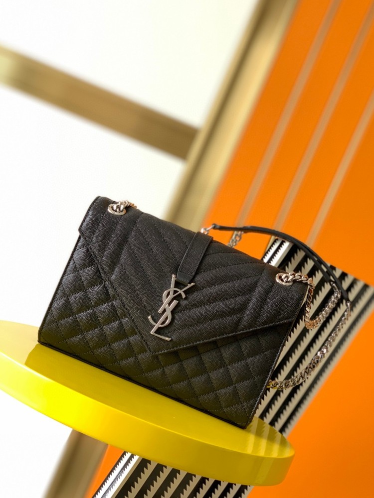 This is the YSL Envelope chain bag, crafted from black grained quilted leather with a silver-tone metal YSL logo, suitable for shoulder or crossbody wear.