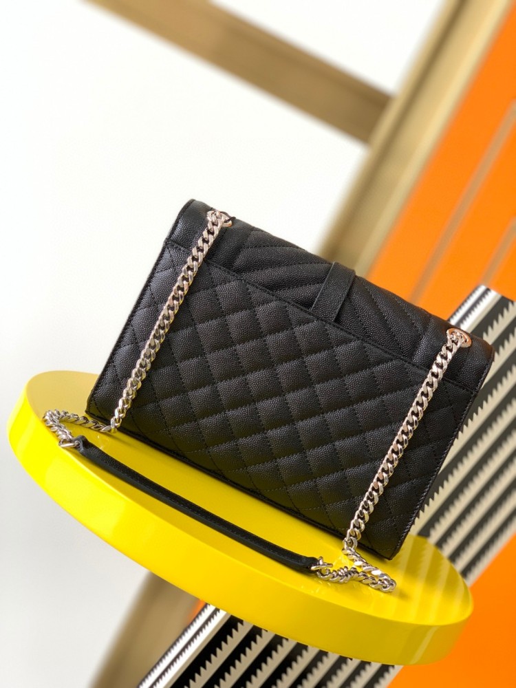 This is the YSL Envelope chain bag, crafted from black grained quilted leather with a silver-tone metal YSL logo, suitable for shoulder or crossbody wear.