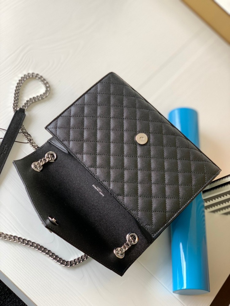This is the YSL Envelope chain bag, crafted from black grained quilted leather with a silver-tone metal YSL logo, suitable for shoulder or crossbody wear.