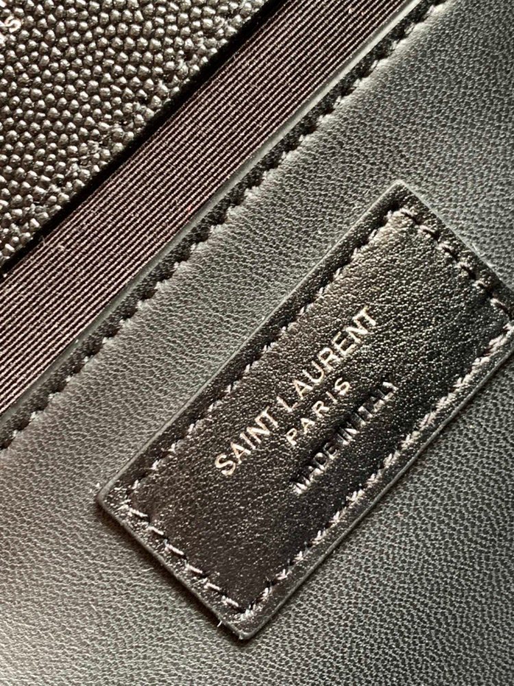 This is the YSL Envelope chain bag, crafted from black grained quilted leather with a silver-tone metal YSL logo, suitable for shoulder or crossbody wear.