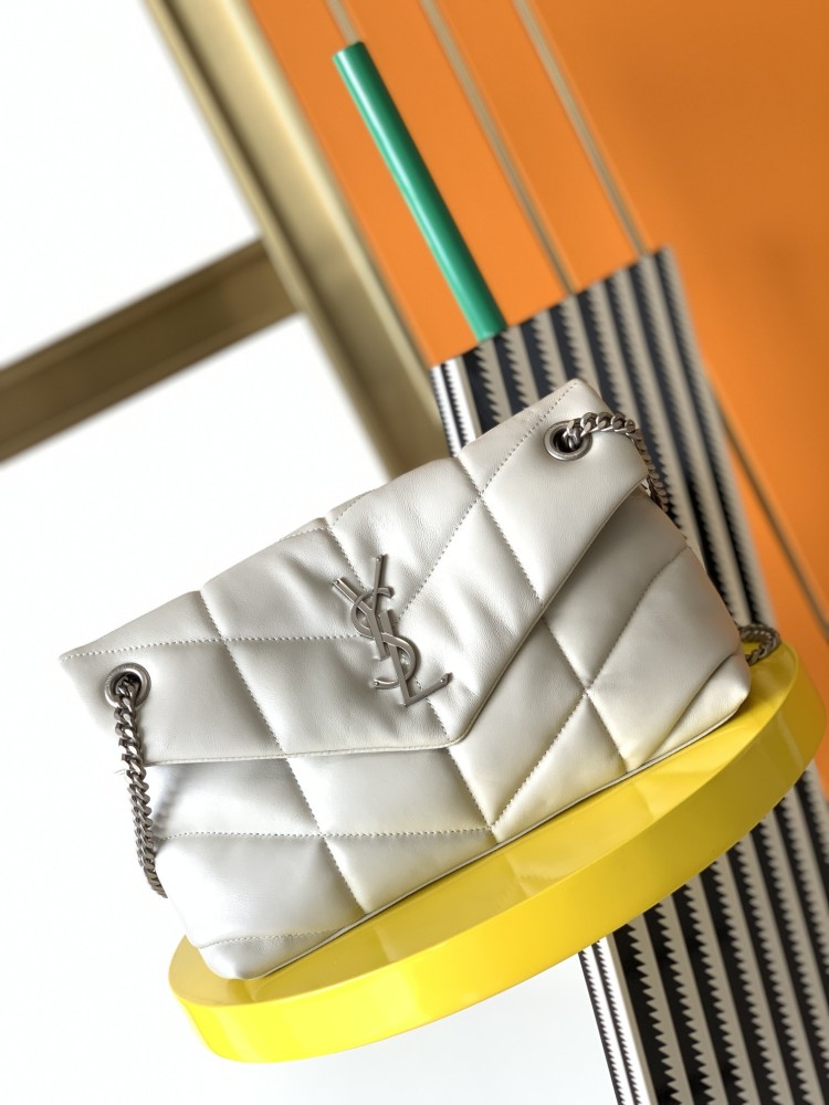 This is the YSL Loulou Puffer quilted bag, crafted from white soft leather with a silver YSL logo, featuring a relaxed yet sophisticated style and suitable for shoulder or crossbody wear.