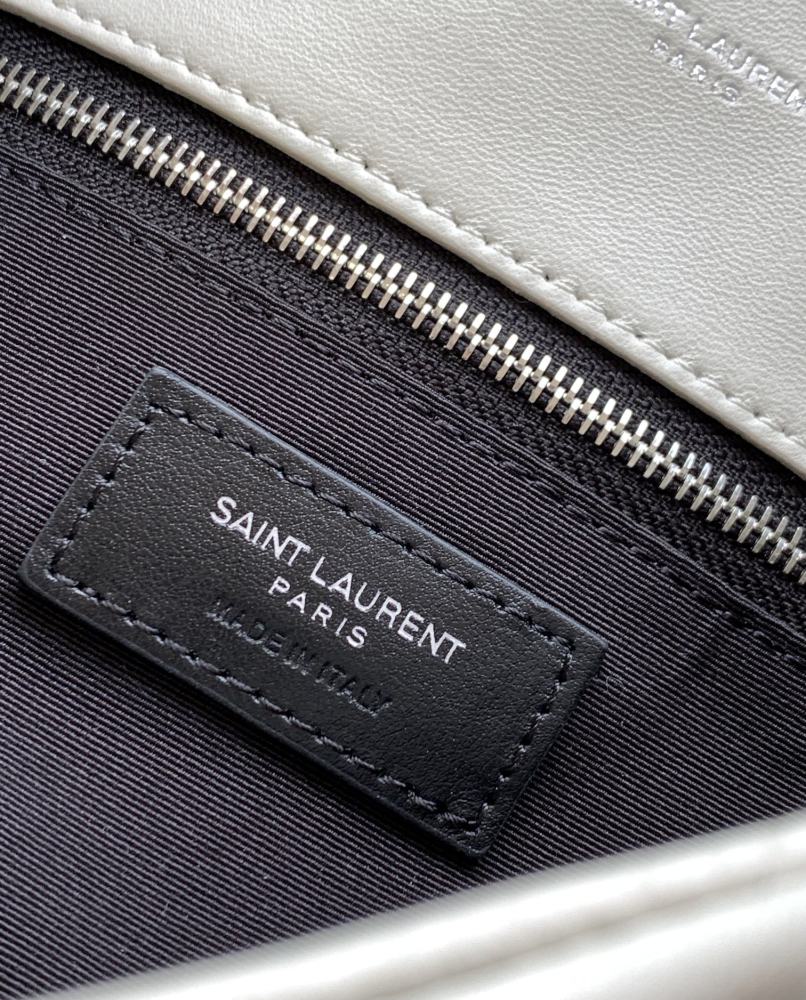 This is the YSL Loulou Puffer quilted bag, crafted from white soft leather with a silver YSL logo, featuring a relaxed yet sophisticated style and suitable for shoulder or crossbody wear.