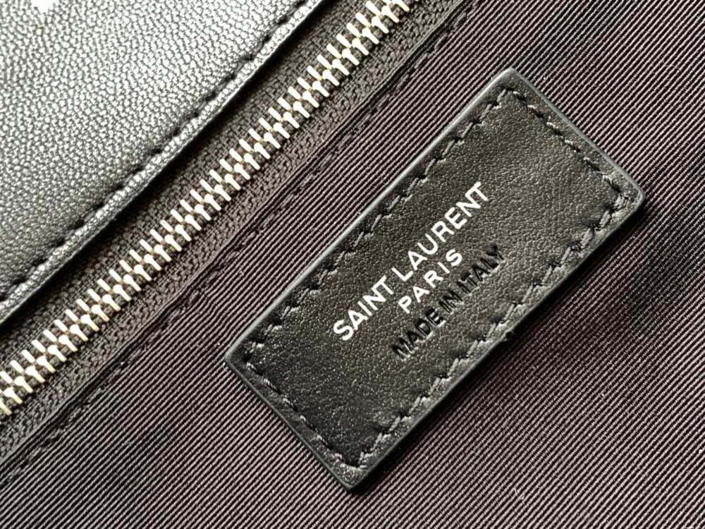 This is the YSL Loulou Puffer quilted bag, crafted from black soft leather with a silver YSL logo, featuring a relaxed yet sophisticated style and suitable for shoulder or crossbody wear.
