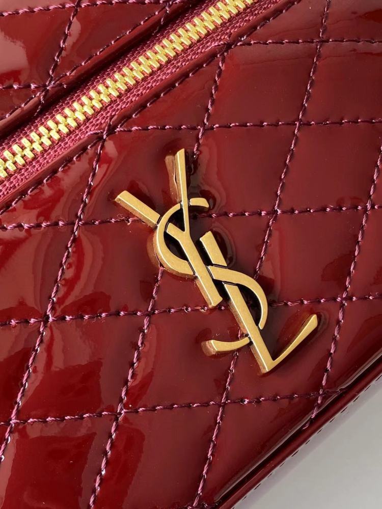 This is the YSL burgundy patent leather vanity bag with quilted stitching, featuring a top handle and crossbody strap.