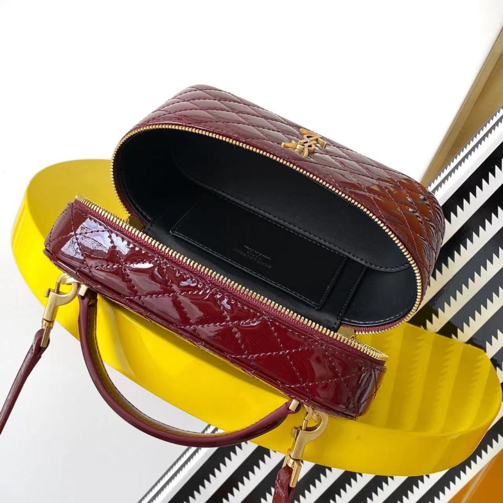 This is the YSL burgundy patent leather vanity bag with quilted stitching, featuring a top handle and crossbody strap.