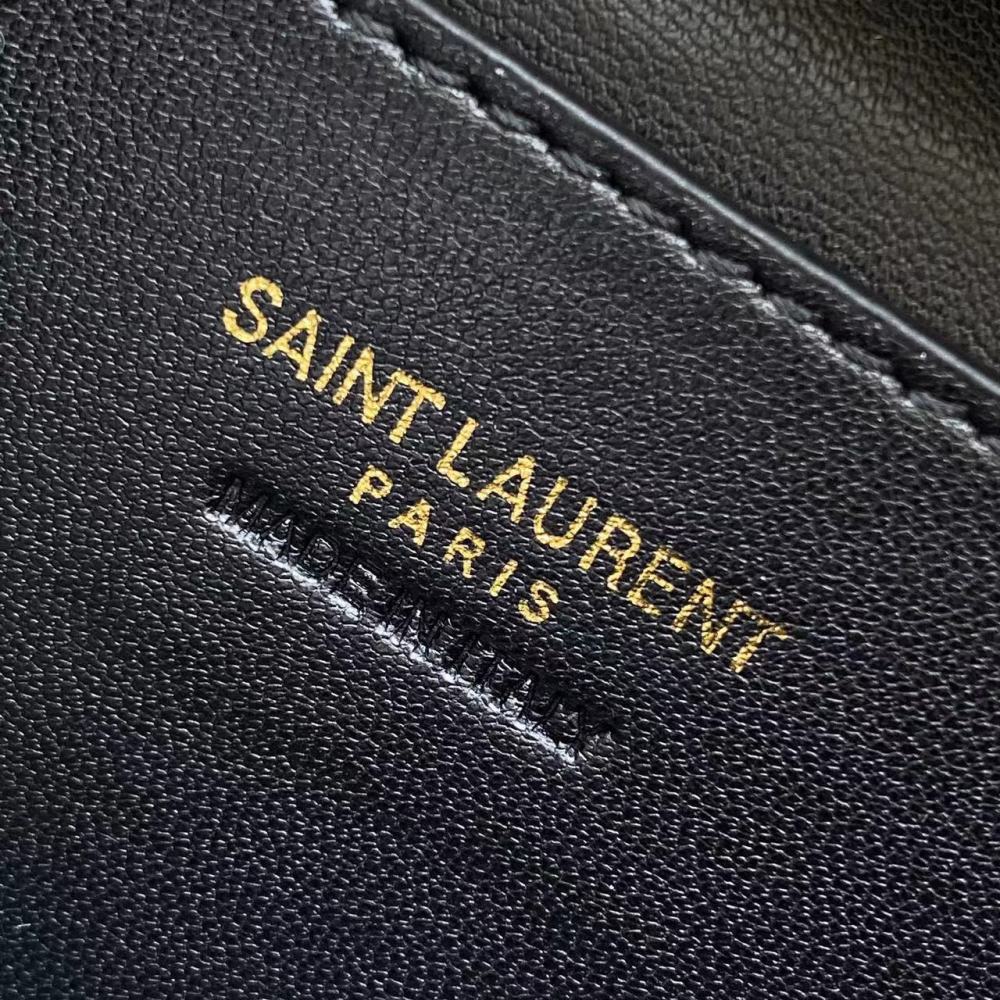 This is the YSL burgundy patent leather vanity bag with quilted stitching, featuring a top handle and crossbody strap.