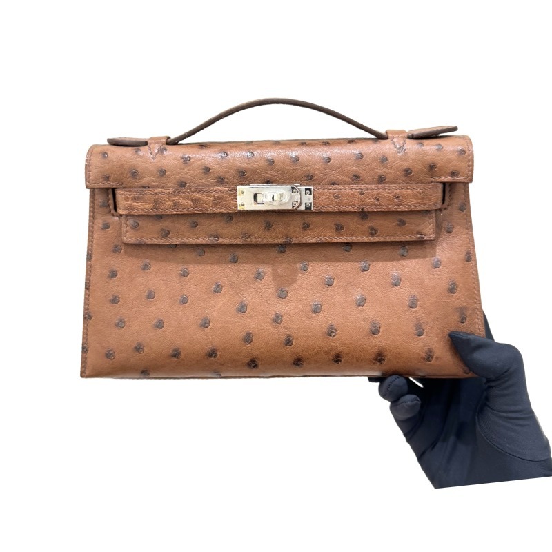 The Hermès Mini Kelly I (also known as the Kelly Pochette) Ostrich Leather Handbag is one of the brand's classic exotic leather models.
