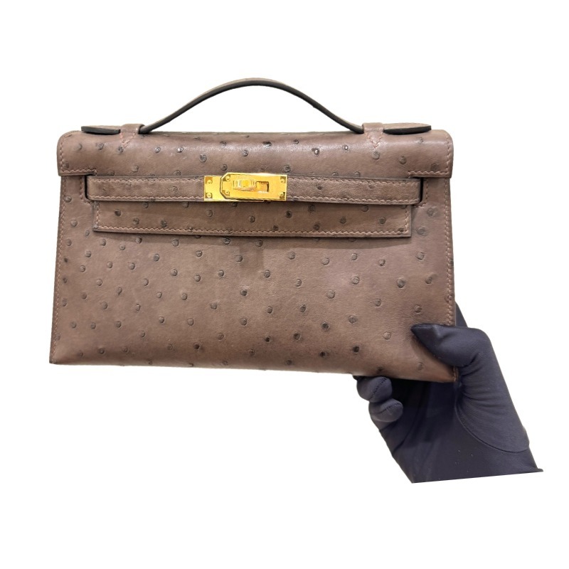 The Hermès Mini Kelly I (also known as the Kelly Pochette) Ostrich Leather Handbag is one of the brand's classic exotic leather models.