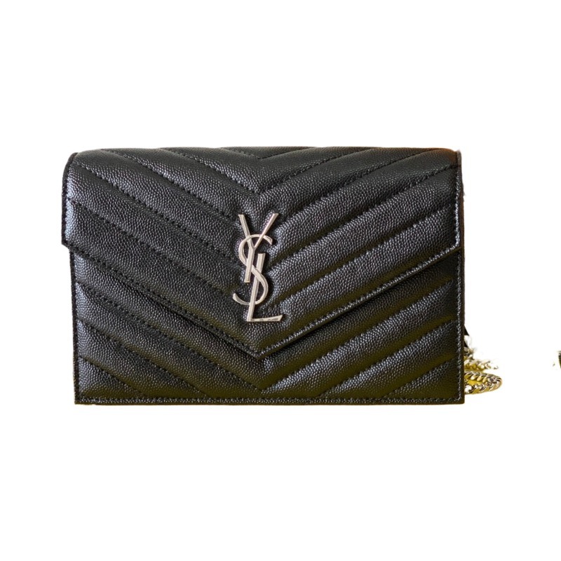 This is the YSL Cassandre chain wallet, crafted from black grained leather with quilted detailing and a silver-tone metal chain, suitable for shoulder or crossbody wear.