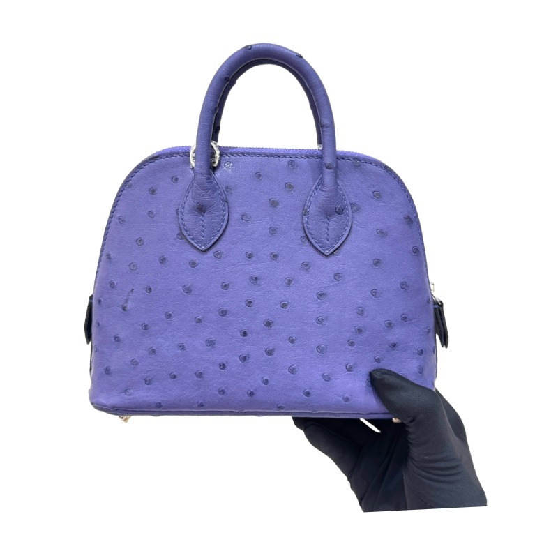 The Hermès Mini Bolide handbag in ostrich leather—featuring a striking Iris (Electric Purple) hue paired with silver hardware—stands as a highly distinctive, niche piece within Hermès' rare leather collection.