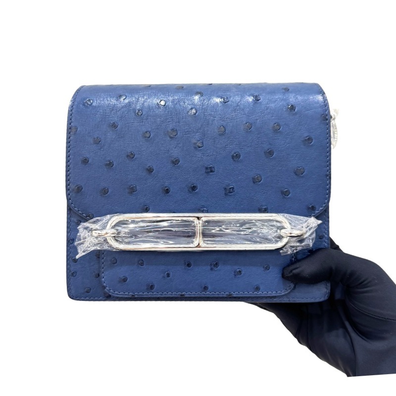 The Hermès Roulis 19 (the "Pig-Nose" bag) in Ostrich leather—featuring a sophisticated Haze Blue (or Sailor Blue) hue paired with silver hardware—stands as a quintessential example of understated luxury within Hermès' rare leather collection.