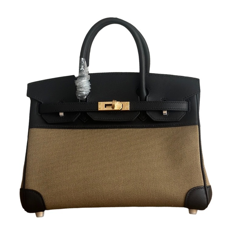 This Birkin-style tote bag features a military green canvas and black leather exterior, giving it a rugged yet retro look with a strong workwear feel.