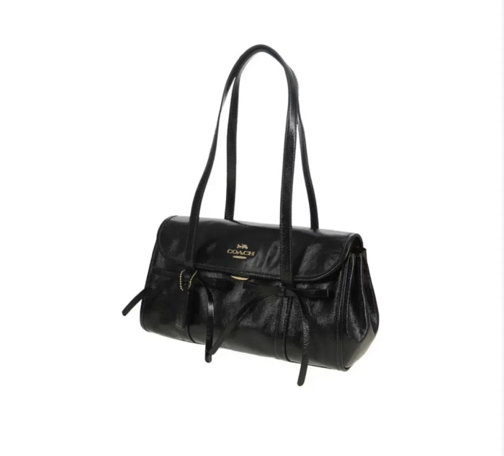 COACH Bridget 34 large black women’s shoulder bag featuring a bow accent, classic gold-tone logo, and smooth pebbled leather.