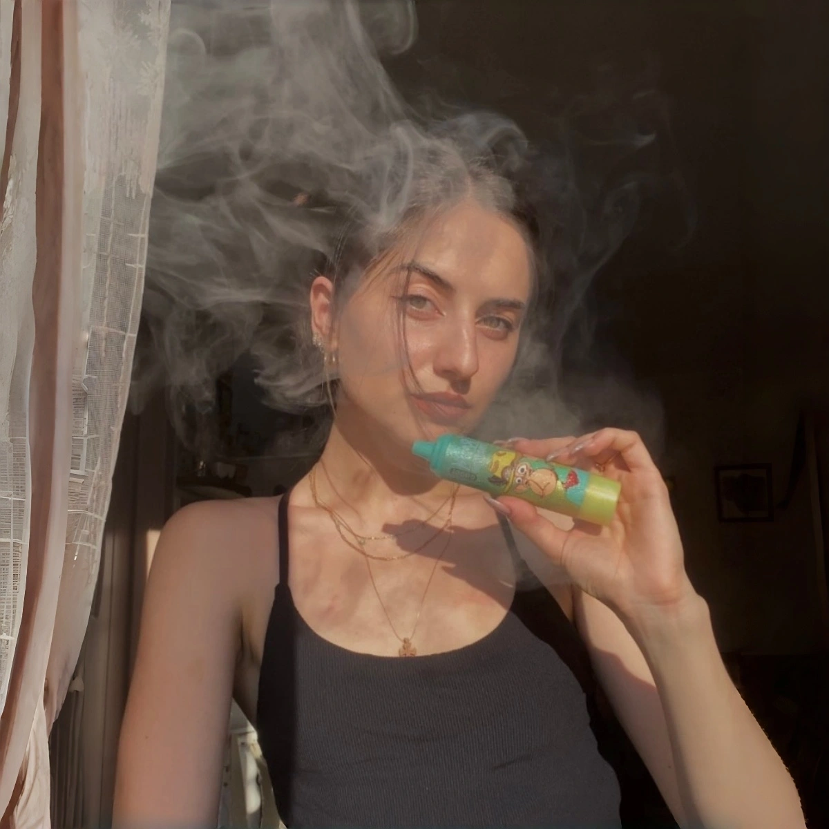 Fumot Tornado 15000 disposable vape in Watermelon Ice flavor, held by a female model to show actual size and handheld design. Real-life product shot.
