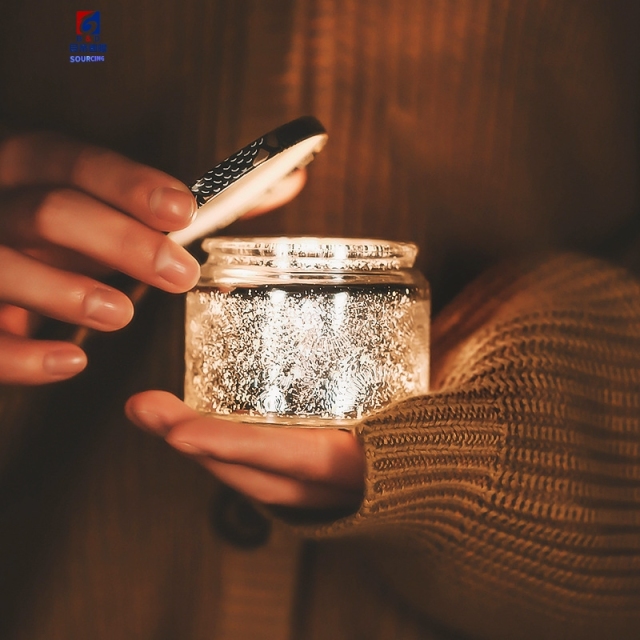 An Empty Jar Of Colored Scented Candles