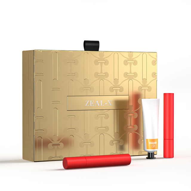 Zeal-X gold rigid cosmetic gift box displayed with lipstick, lip balm and serum tube