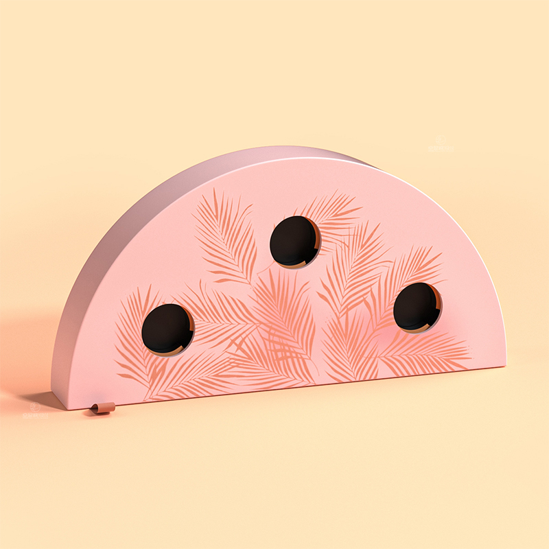 Closed pink half-moon beauty box with a botanical patterned sleeve and three circular openings.