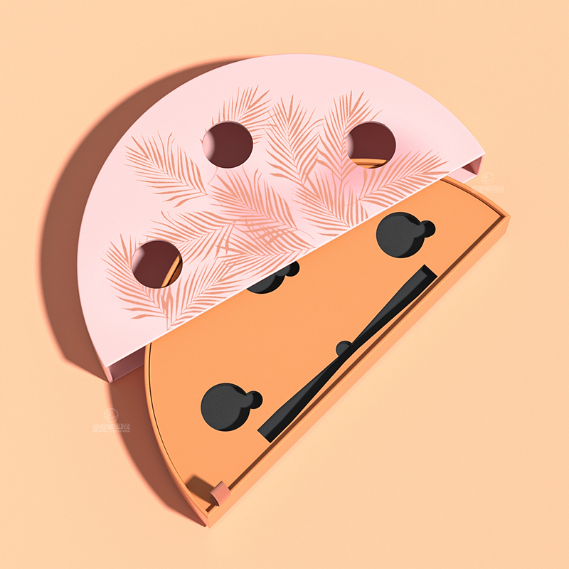 Open pink half-moon beauty box with a botanical patterned sleeve, orange inner tray, black EVA insert and ribbon pull.
