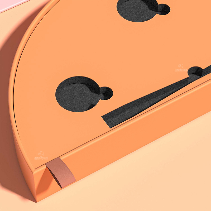 Close-up of the orange inner tray with black EVA recesses and a ribbon pull inside a half-moon beauty box.