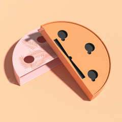 Angled view of an open half-moon beauty box with circular item recesses, a long tool slot and ribbon pull.