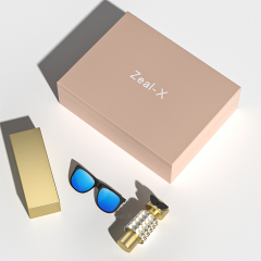 Closed blush pink gift box shown with perfume, sunglasses and a boxed sunscreen product