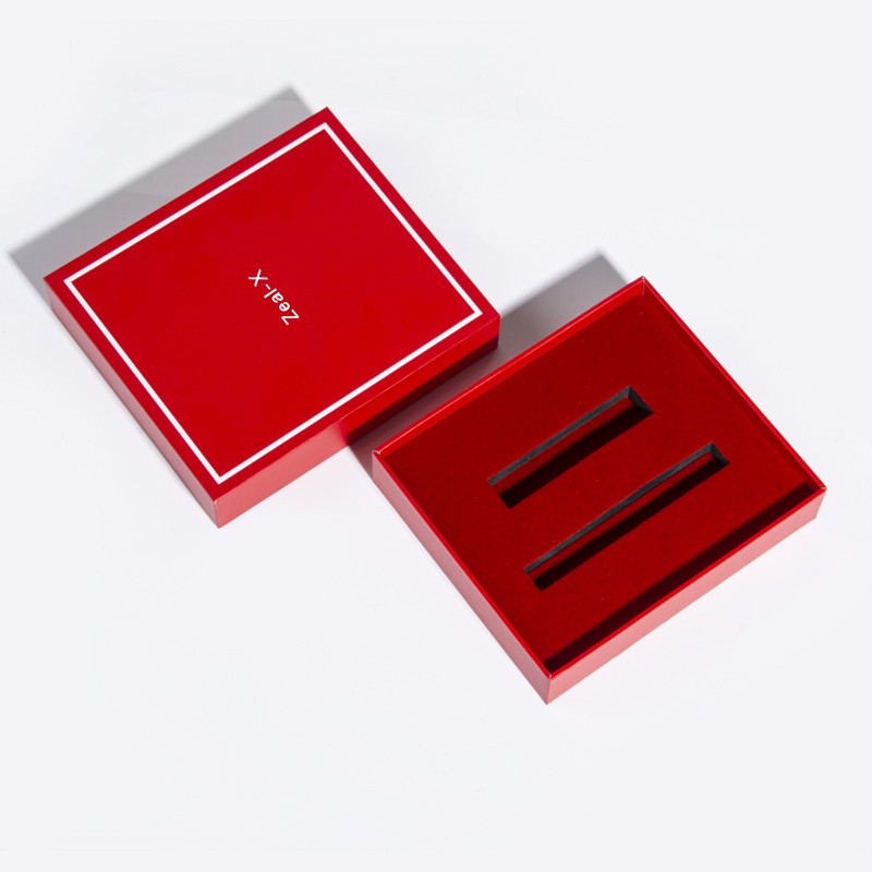 Red makeup gift box with the lid removed to reveal two long rectangular insert slots