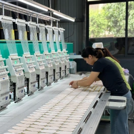 Operators running multi-head embroidery machines on the production floor of our Guangzhou plush toy factory