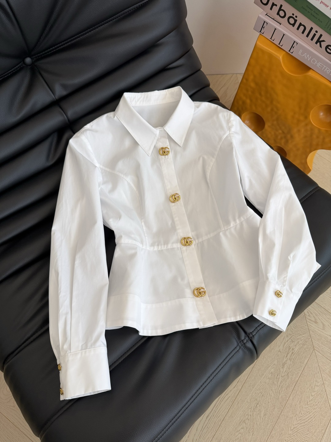 Elegant blouse decorated with iconic interlocking GG gold buttons., Cailan (Chongqing) International Trading Co., Ltd,Elegant blouse decorated with iconic interlocking GG gold buttons.