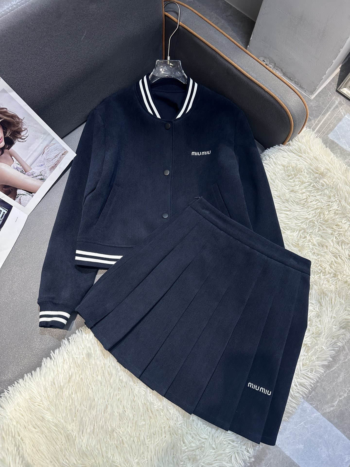 Cropped baseball jacket + high‑waist pleated midi skirt., Cailan (Chongqing) International Trading Co., Ltd,Cropped baseball jacket + high‑waist pleated midi skirt.- Cailan (Chongqing) International Trading Co., Ltd