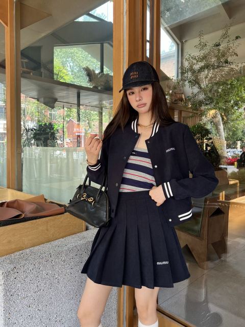 Cropped baseball jacket + high‑waist pleated midi skirt., Cailan (Chongqing) International Trading Co., Ltd,Cropped baseball jacket + high‑waist pleated midi skirt.- Cailan (Chongqing) International Trading Co., Ltd