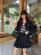 Cropped baseball jacket + high‑waist pleated midi skirt.