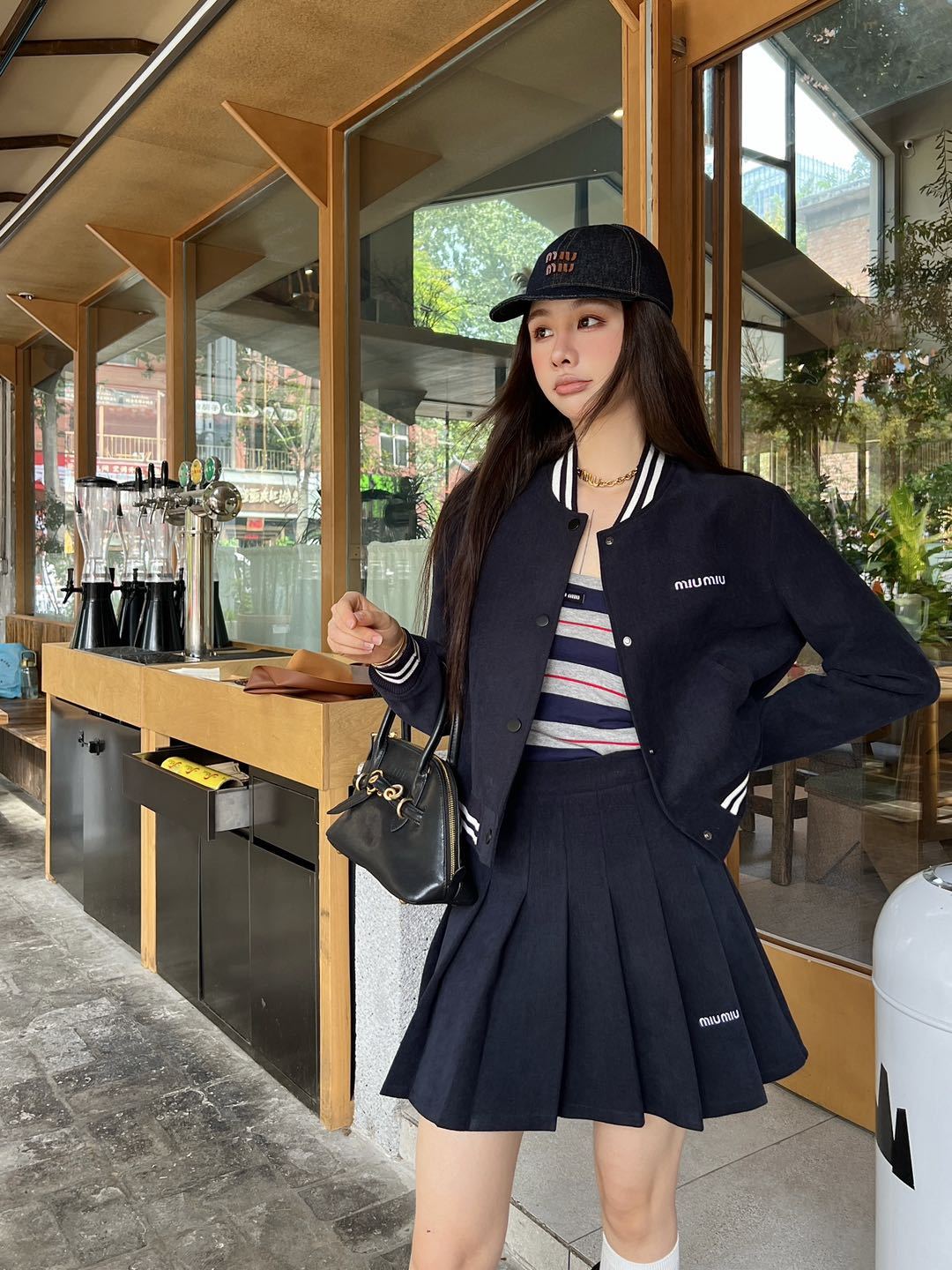 Cropped baseball jacket + high‑waist pleated midi skirt., Cailan (Chongqing) International Trading Co., Ltd,Cropped baseball jacket + high‑waist pleated midi skirt.- Cailan (Chongqing) International Trading Co., Ltd