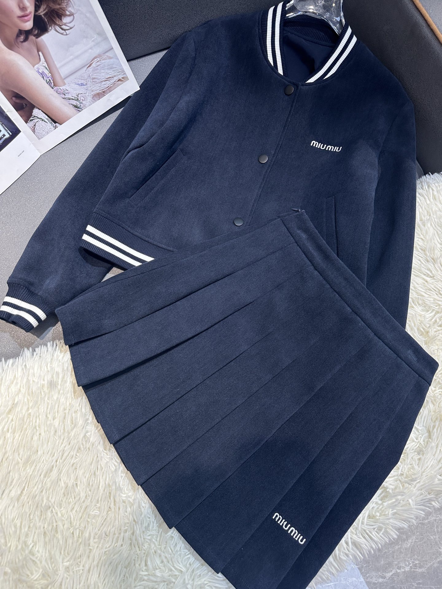 Cropped baseball jacket + high‑waist pleated midi skirt., Cailan (Chongqing) International Trading Co., Ltd,Cropped baseball jacket + high‑waist pleated midi skirt.- Cailan (Chongqing) International Trading Co., Ltd