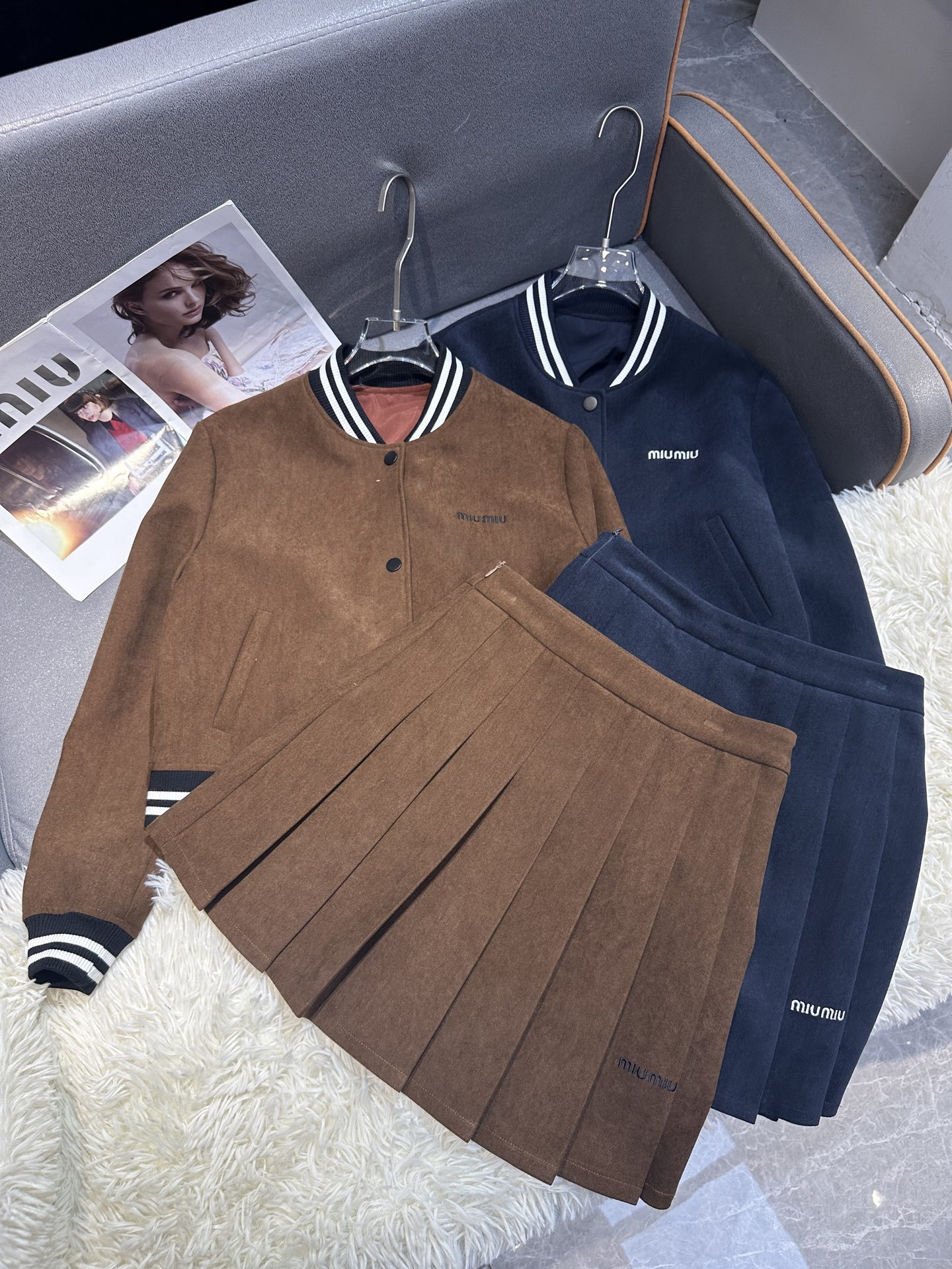 Cropped baseball jacket + high‑waist pleated midi skirt., Cailan (Chongqing) International Trading Co., Ltd,Cropped baseball jacket + high‑waist pleated midi skirt.- Cailan (Chongqing) International Trading Co., Ltd