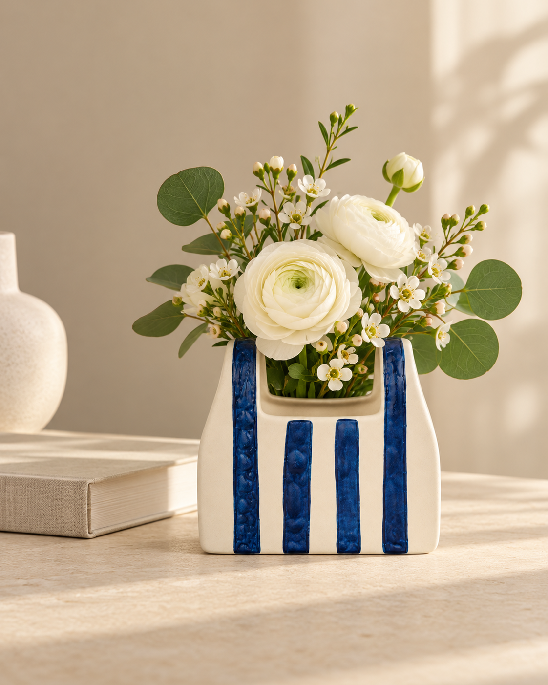 ATW-S252344-A cobalt stripe basket-form stoneware floral vessel with botanical arrangement in styled interior