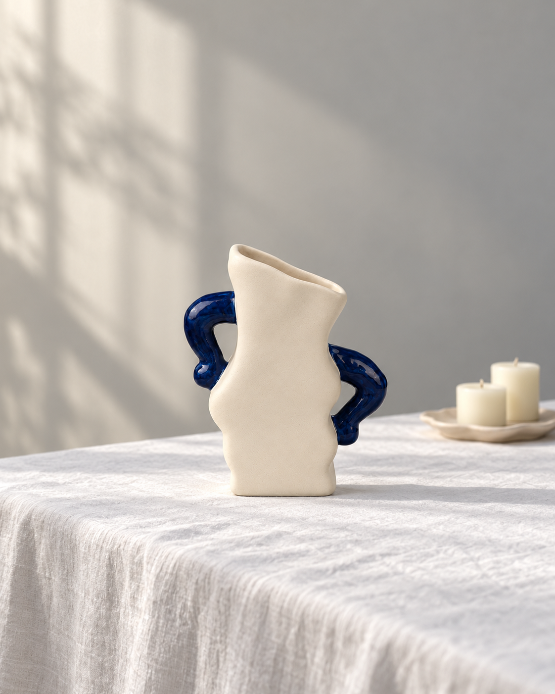 ATW-S252342-A sculptural wave cream and cobalt stoneware floral vessel empty in styled interior