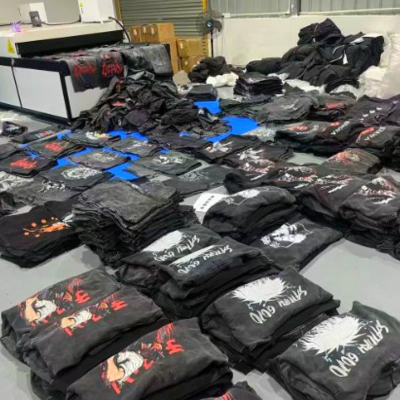 Cosmox DTG printer printed black hoodies wait for heating tunnel