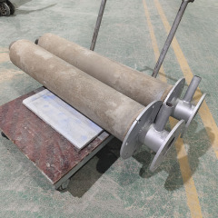 Molten aluminum refractory nozzle with metal shell