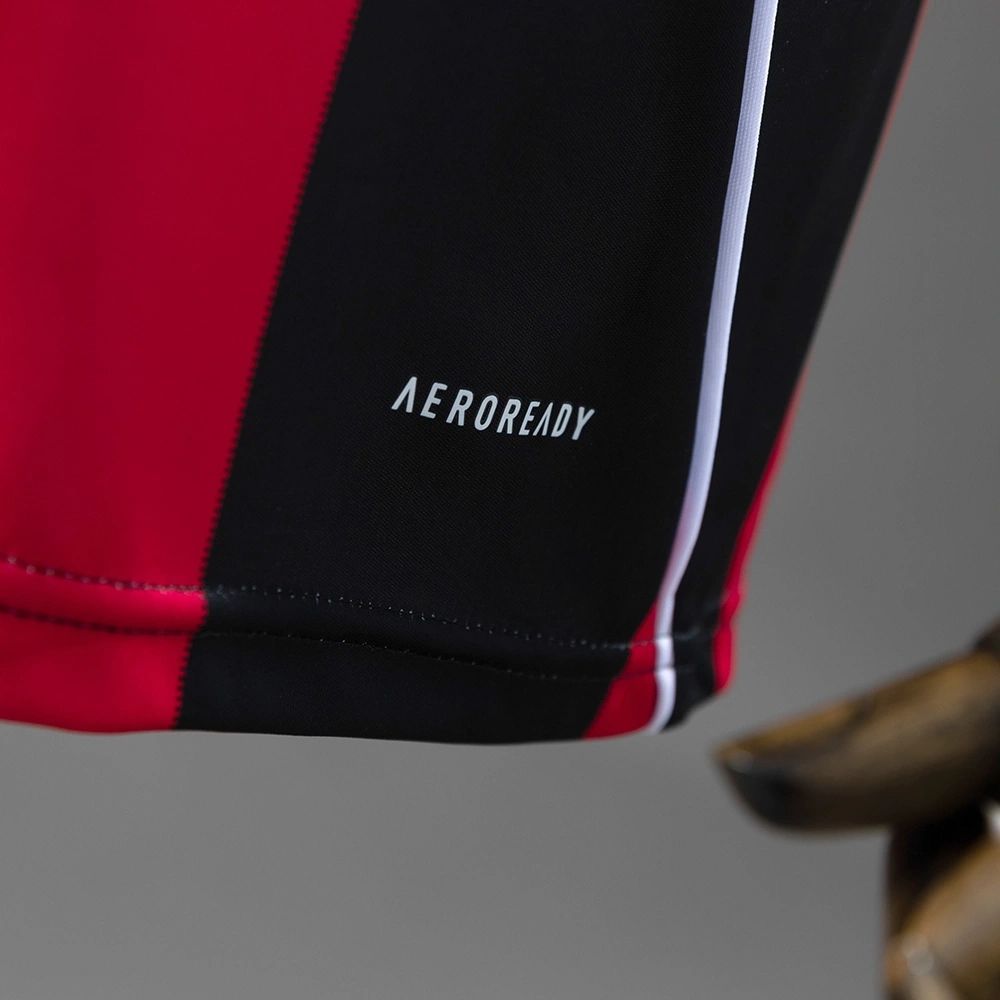 Hem detail of the 2025-26 Eintracht Frankfurt home jersey highlighting the AEROREADY performance fabric label on the red and black stripe.