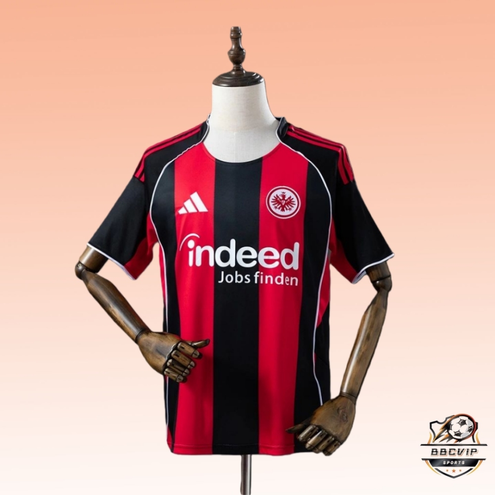 Front view of the Eintracht Frankfurt 2025-26 home jersey fan version, featuring black and red vertical stripes, Indeed sponsor logo, Adidas branding, and club crest on a mannequin.