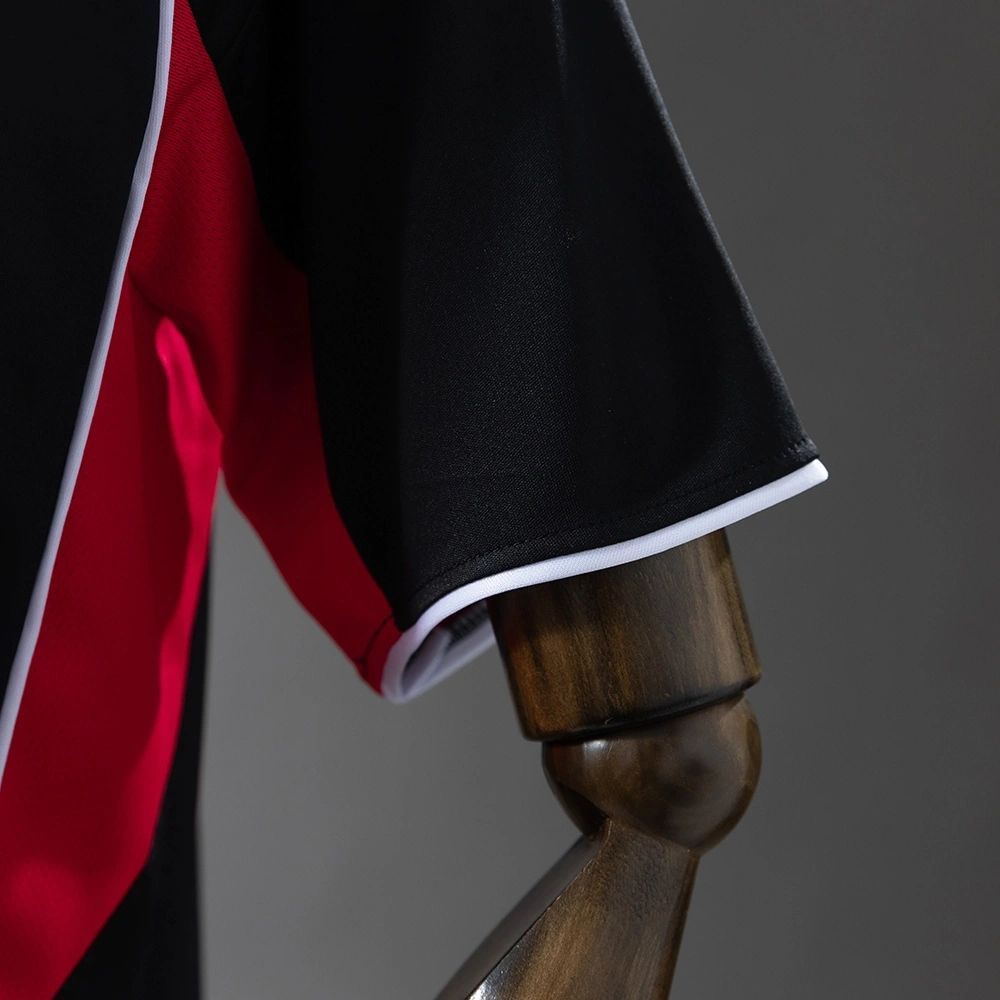 Eintracht Frankfurt 2025-26 home jersey sleeve detail close-up showing black fabric with white trim and red panel, highlighting the high-quality construction of the new Bundesliga kit.