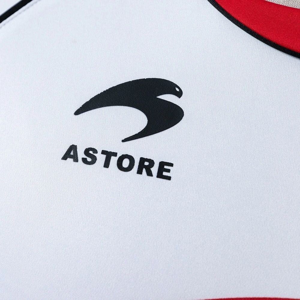 Close-up of the black Astore manufacturer logo printed on the white Osasuna 2010-11 away jersey.